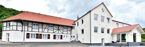 Een modern gebouw met een traditioneel vakwerkhuis. De architectuur combineert oud en nieuw in een uitnodigende omgeving.