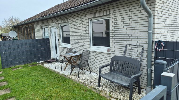 A cozy house with a small garden.
Outside there are seating areas and the outdoor space is well maintained.