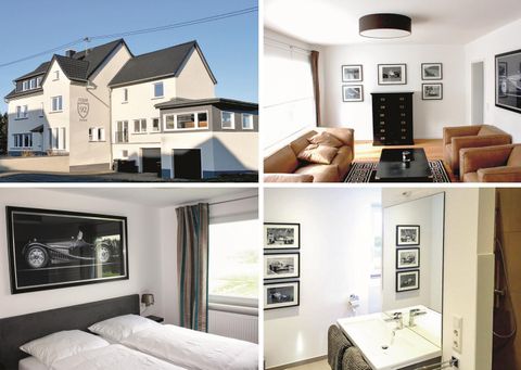 Ein modernes Gebäude mit einer hellen Fassade und stilvollen Innenräumen. Die Zimmer sind elegant eingerichtet, mit Bildern an den Wänden und bequemen Möbeln.