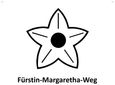Symbol eines fünfzackigen Sterns mit einem Kreis in der Mitte, darunter der Text 'Fürstin-Margaretha-Weg'.