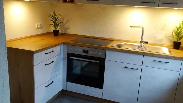 Cuisine avec réfrigérateur, four, cuisinière électrique et lave-vaisselle